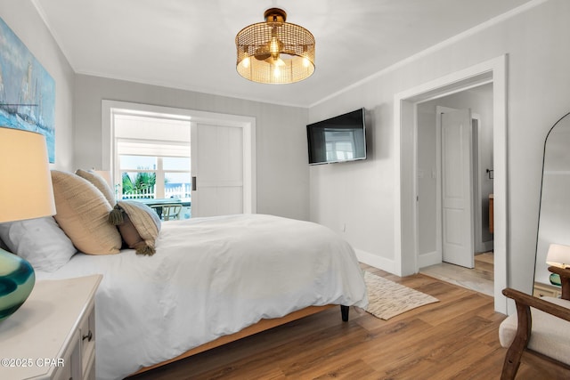 13011 Oleander, Panama City Beach, FL 32407 - bedroom featuring light wood-style floors, crown molding, and baseboards