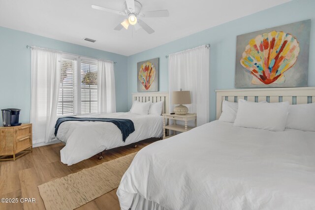 13011 Oleander, Panama City Beach, FL 32407 - bedroom with ceiling fan, wood finished floors, and visible vents
