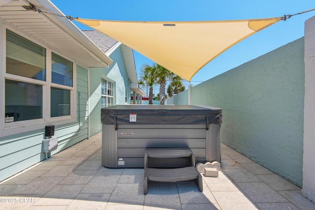 13011 Oleander, Panama City Beach, FL 32407 - view of patio with a hot tub and fence