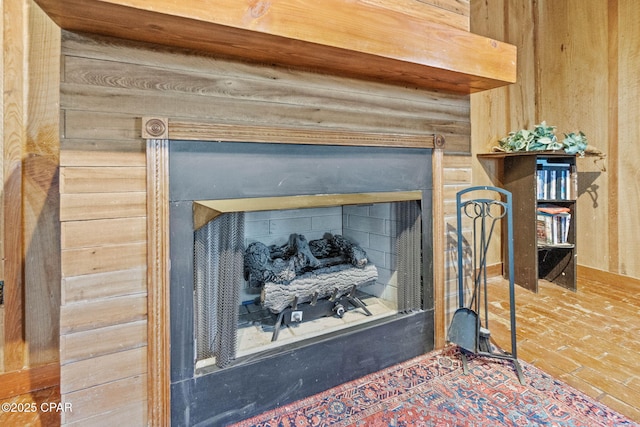 room details featuring a fireplace and wooden walls