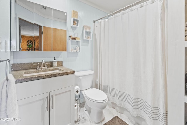 full bathroom featuring toilet, vanity, and a shower with curtain