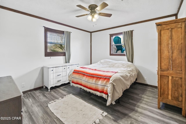 bedroom with ceiling fan, wood finished floors, baseboards, and ornamental molding