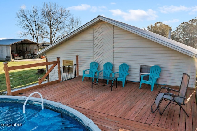 wooden terrace featuring a yard