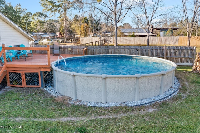 view of swimming pool featuring a fenced in pool, a deck, and fence