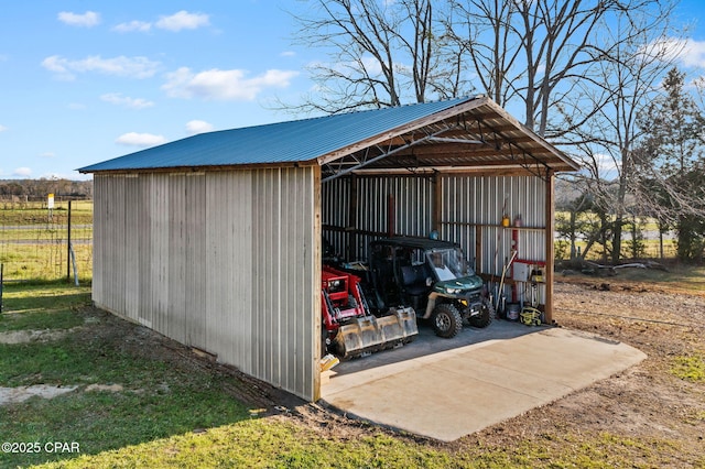 view of pole building with a carport and driveway