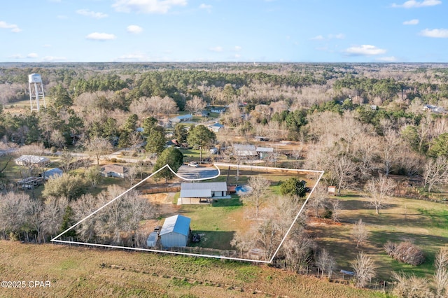 birds eye view of property with a wooded view