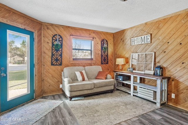 sitting room with a textured ceiling and wood finished floors