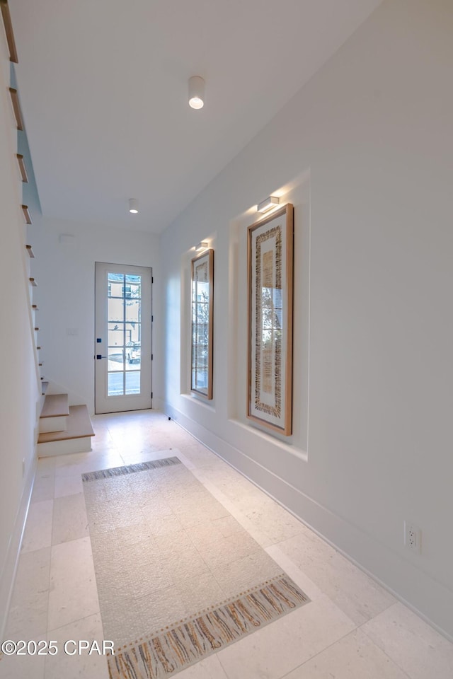 entrance foyer with stairway and baseboards