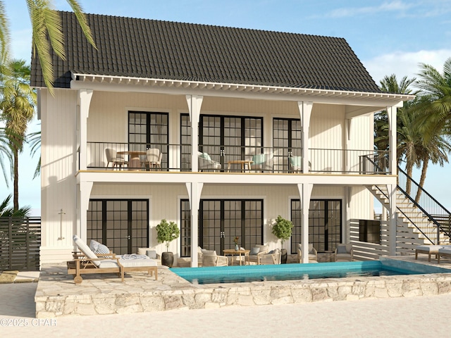 rear view of property with a balcony, stairs, and a patio