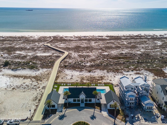 bird's eye view featuring a water view and a view of the beach
