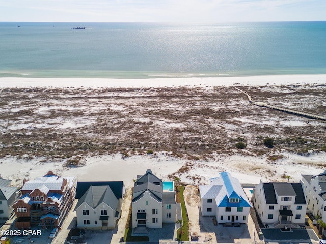 birds eye view of property with a residential view, a water view, and a beach view