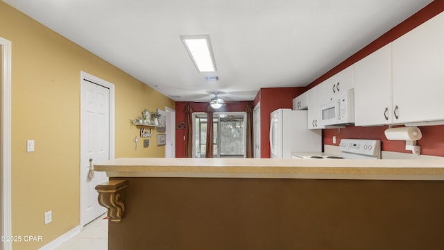 kitchen with white cabinets, white appliances, light countertops, and a peninsula