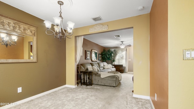 living area featuring visible vents, baseboards, a notable chandelier, and carpet flooring