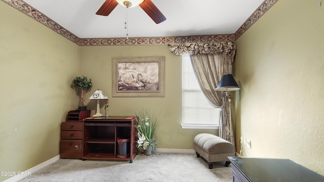 sitting room with baseboards, carpet floors, and a ceiling fan