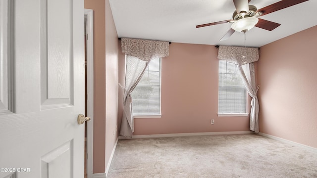 unfurnished room featuring baseboards, carpet floors, and ceiling fan