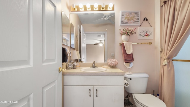 bathroom with visible vents, toilet, ceiling fan, and vanity