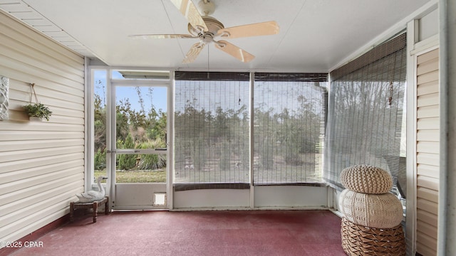 unfurnished sunroom with ceiling fan