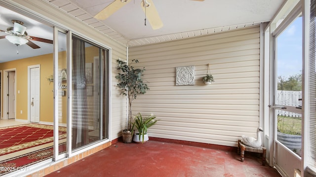 unfurnished sunroom with a ceiling fan