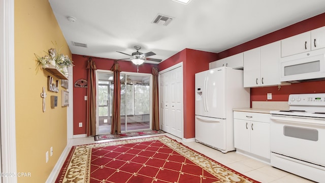 kitchen with visible vents, white appliances, light countertops, and white cabinetry