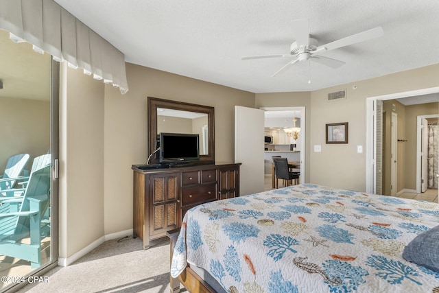 bedroom featuring a ceiling fan, baseboards, visible vents, carpet floors, and a textured ceiling