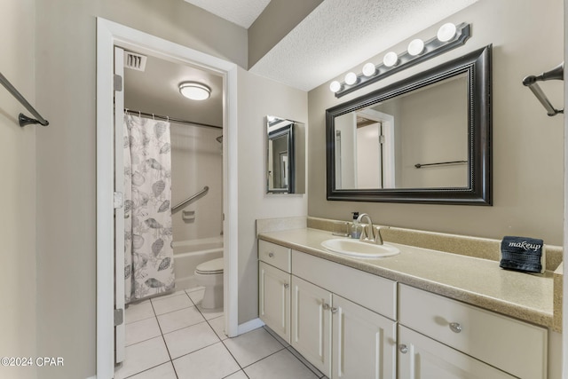 full bathroom with vanity, shower / bath combo with shower curtain, a textured ceiling, tile patterned floors, and toilet