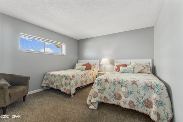 carpeted bedroom featuring baseboards and a textured ceiling