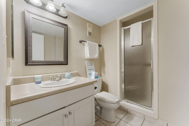 bathroom featuring tile patterned floors, toilet, a textured ceiling, a shower stall, and vanity