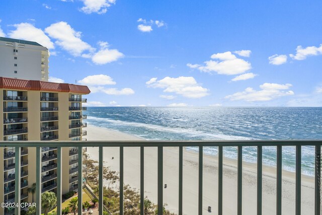 exterior space with a water view and a beach view