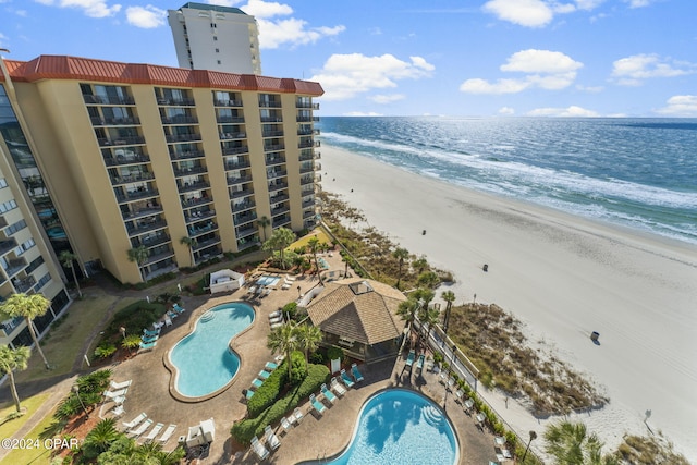 birds eye view of property with a view of the beach and a water view