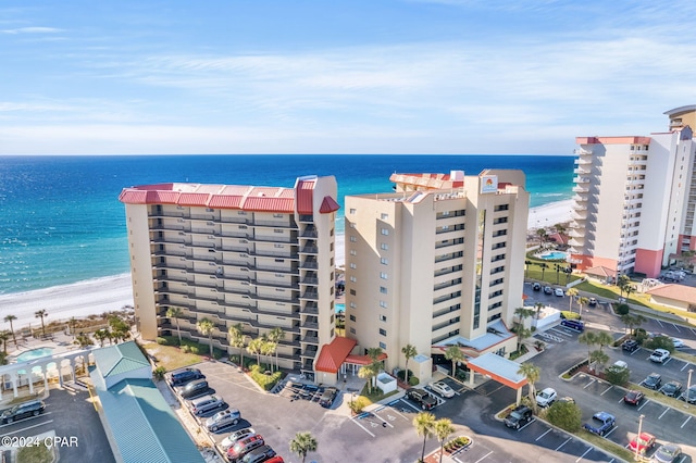 drone / aerial view featuring a beach view and a water view