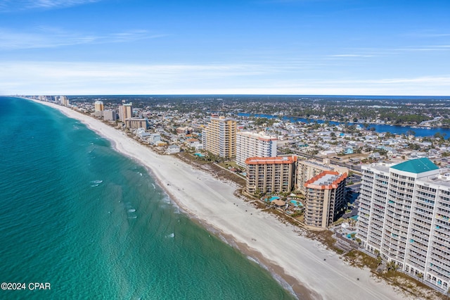 drone / aerial view with a water view, a view of city, and a view of the beach