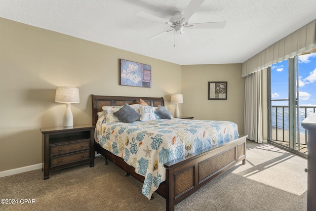 carpeted bedroom with baseboards, a textured ceiling, a ceiling fan, and access to outside