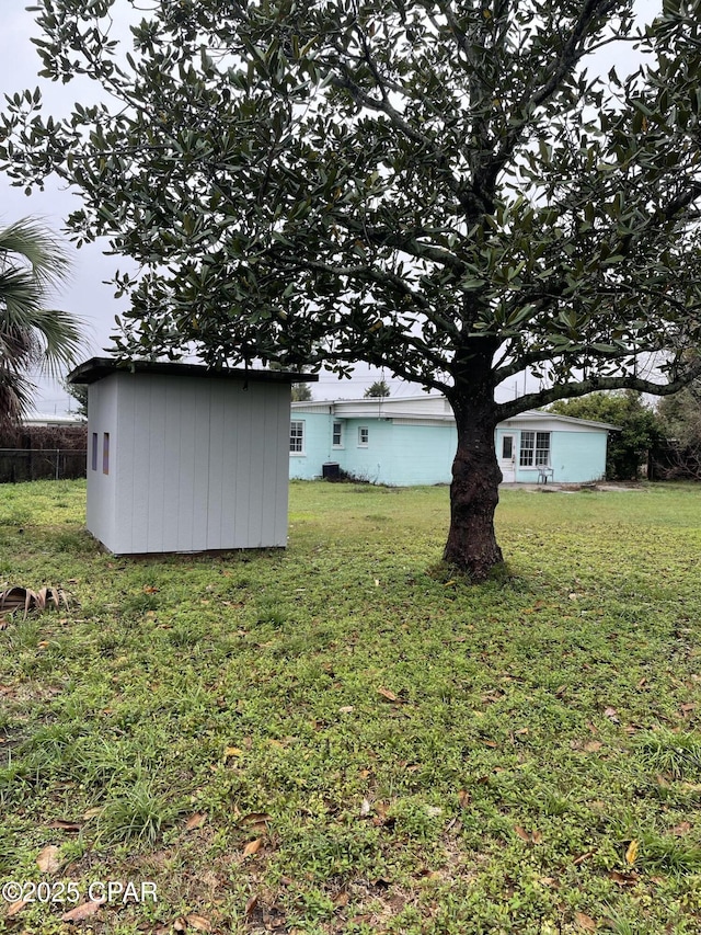 view of yard with an outdoor structure and a shed