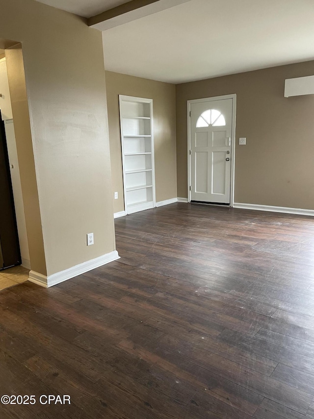 foyer entrance featuring dark wood-style floors, baseboards, and beamed ceiling