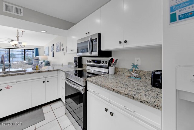 520 Richard Jackson Blvd Unit 3308, Panama City Beach, FL 32407 - kitchen with visible vents, a sink, white cabinetry, stainless steel appliances, and light tile patterned floors
