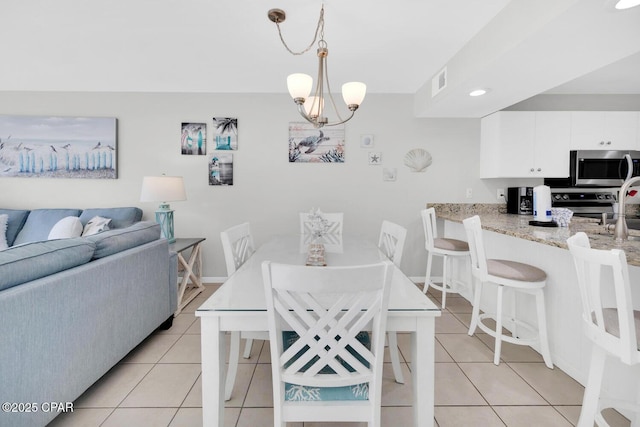 520 Richard Jackson Blvd Unit 3308, Panama City Beach, FL 32407 - dining room with visible vents, baseboards, light tile patterned flooring, and a chandelier