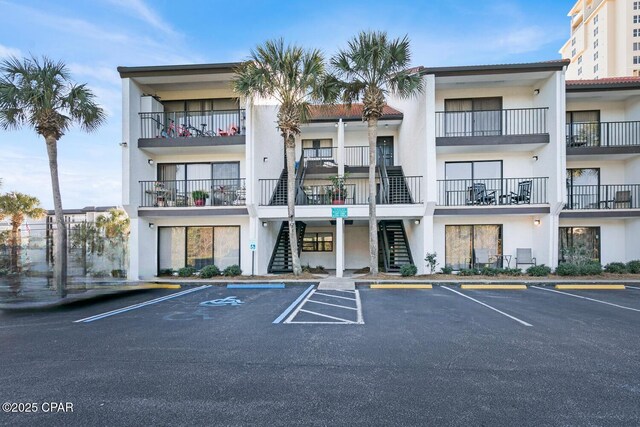 520 Richard Jackson Blvd Unit 3308, Panama City Beach, FL 32407 - view of property featuring stairs and uncovered parking