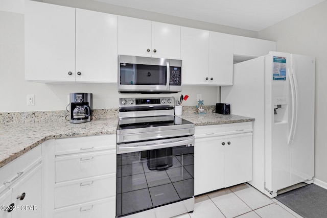 520 Richard Jackson Blvd Unit 3308, Panama City Beach, FL 32407 - kitchen featuring stainless steel appliances, light stone countertops, light tile patterned flooring, and white cabinets