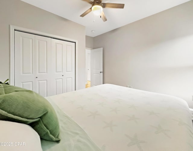 bedroom with ceiling fan and a closet