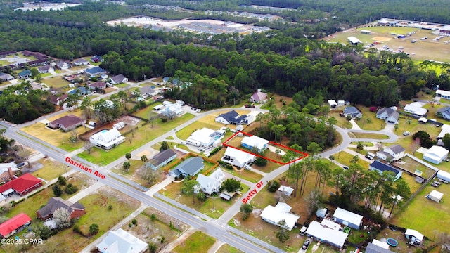 aerial view with a residential view and a view of trees