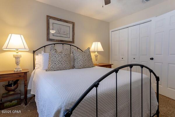 bedroom with carpet floors, ceiling fan, and a closet