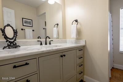 bathroom with vanity and baseboards