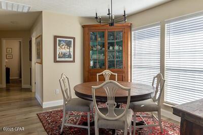 dining area with light wood-type flooring, visible vents, and baseboards