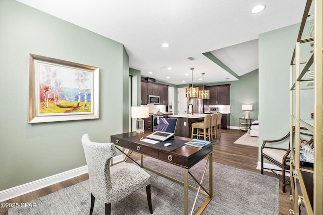 office featuring visible vents, baseboards, recessed lighting, a sink, and dark wood finished floors