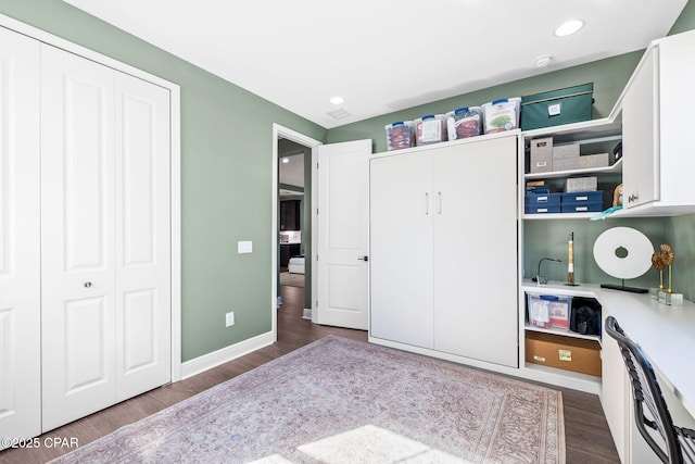 bedroom with recessed lighting, dark wood finished floors, baseboards, and a closet