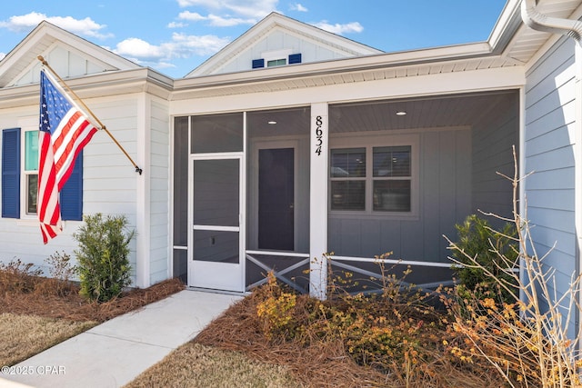 view of exterior entry featuring board and batten siding