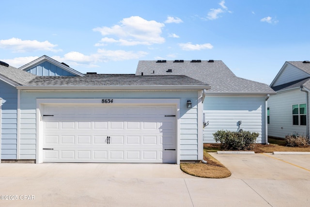 view of front of property featuring roof with shingles and driveway