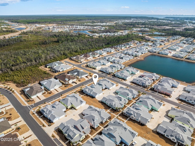 drone / aerial view with a water view and a residential view