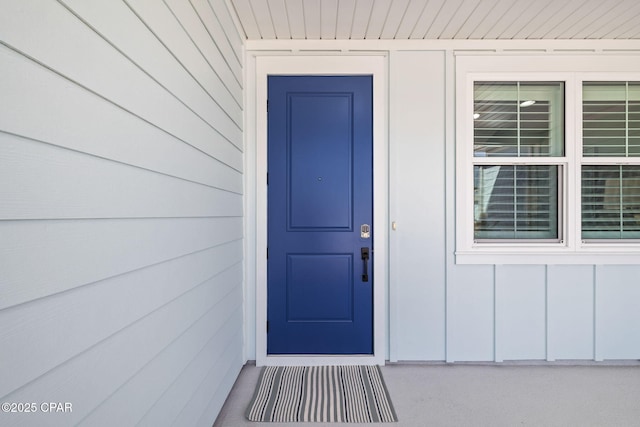 view of exterior entry featuring board and batten siding