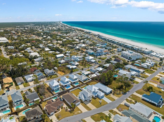 birds eye view of property with a water view and a view of the beach